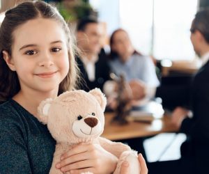 kid hugging a teddy bear