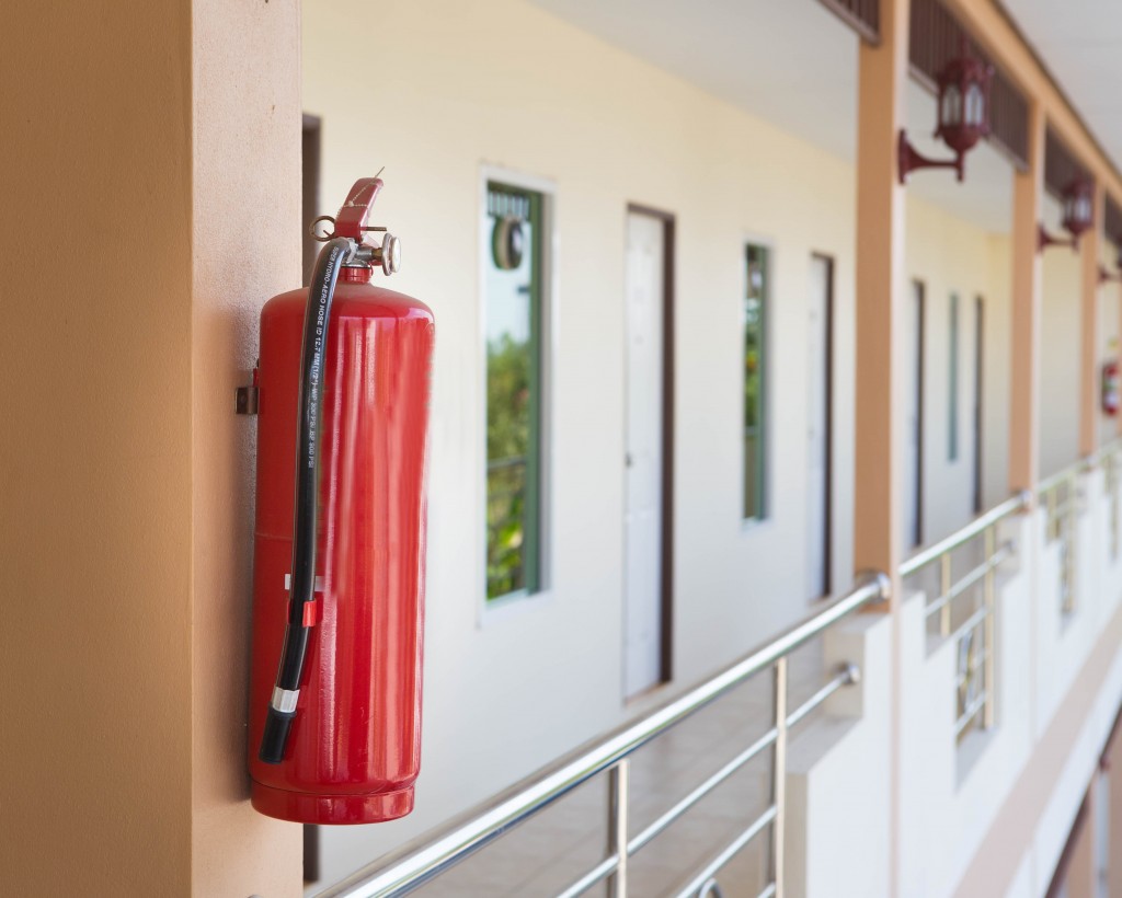 fire extinguisher hanging on a balcony
