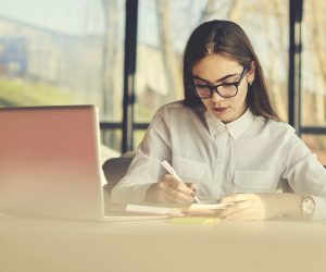 businesswomen writing in her notebook