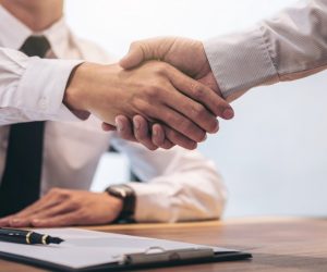 Client and agent handshake insurance agreement