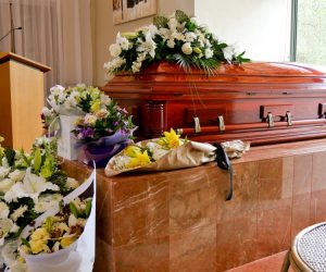 coffin with flowers around it