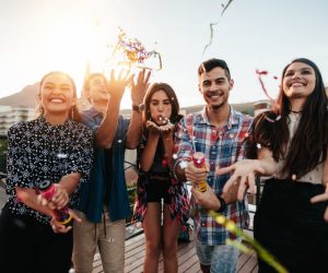 group of friends throwing confetti in a birthday party