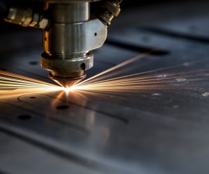 Cutting of metal. Sparks fly from laser