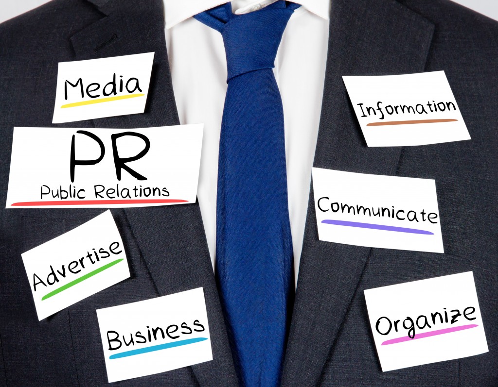Photo of business suit and tie with PR concept paper cards