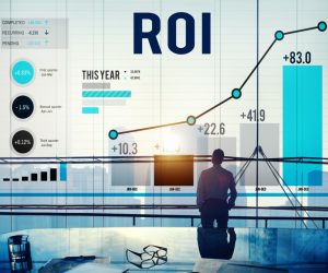 businessman looking an roi chart reflected in the glass of the comference room