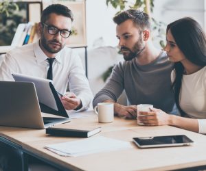 Couple with an agent discussing about mortgage