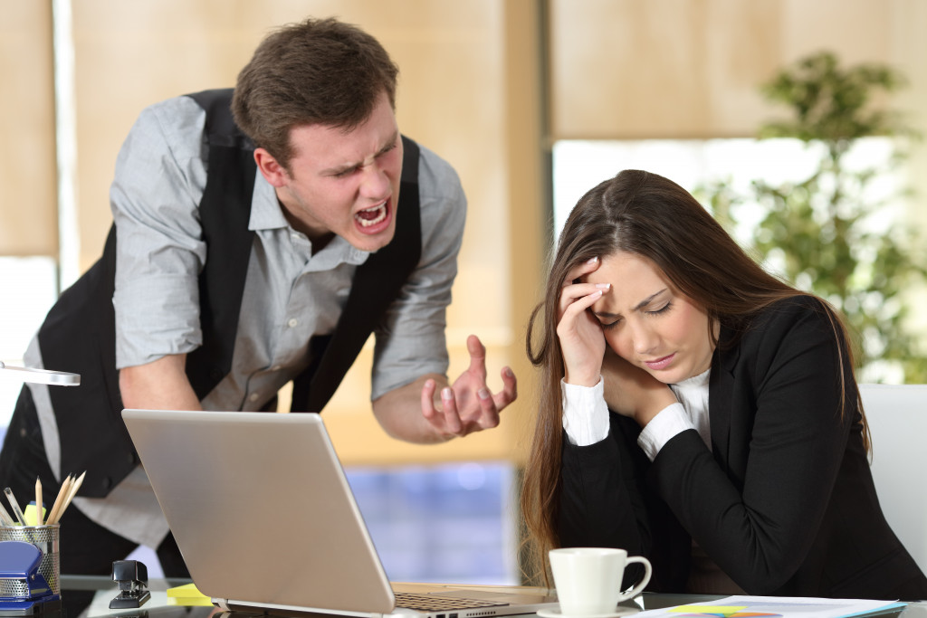 Bullying with an out of control boss shouting to a stressed employee