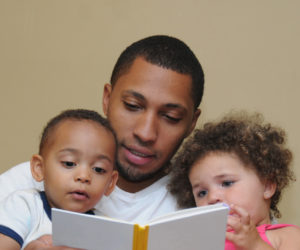 Dad reading to kids