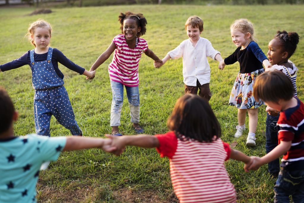 A group of kids playing at the park