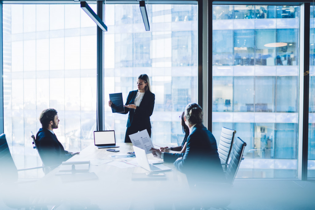  female leading a meeting with people